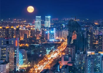 Moonlit modern city skyline scene